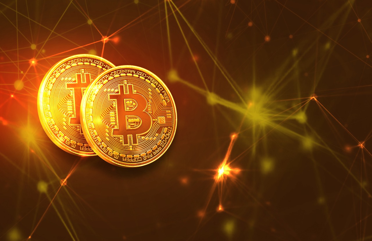 two bitcoins on golden background